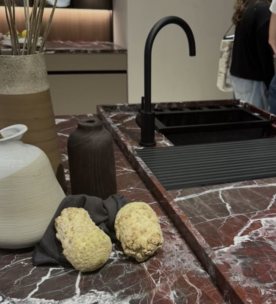 Modern kitchen island with carved cutouts creating separate cooking and dining zones